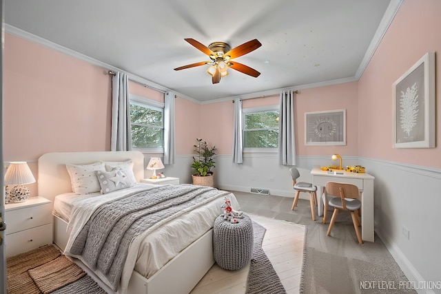 bedroom with crown molding, ceiling fan, light hardwood / wood-style floors, and multiple windows