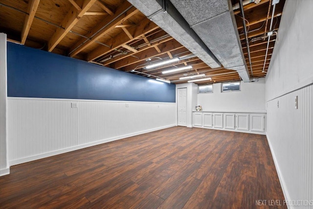 basement with dark hardwood / wood-style flooring