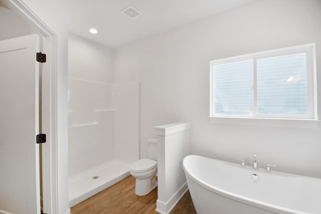 bathroom with plus walk in shower, hardwood / wood-style floors, and toilet