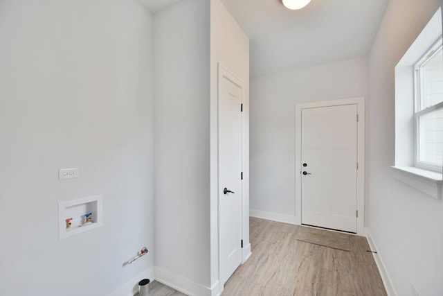 laundry area featuring hookup for a washing machine and light hardwood / wood-style floors