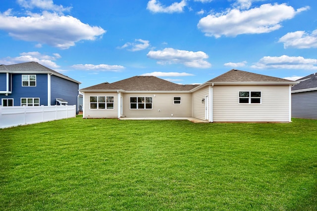 rear view of house featuring a yard and a patio