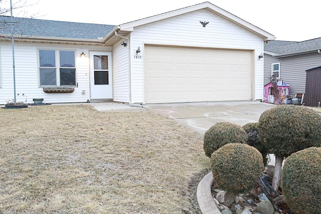 single story home featuring a garage and a front lawn