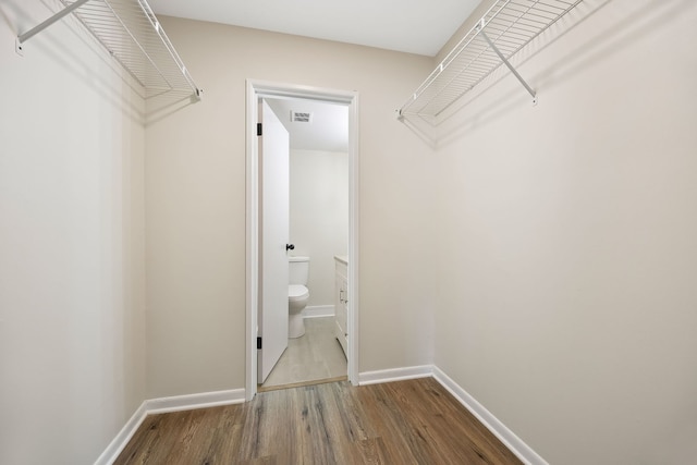 walk in closet featuring hardwood / wood-style flooring