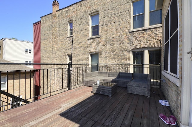 deck with an outdoor living space with a fire pit