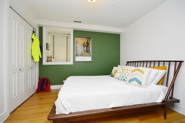 bedroom featuring light hardwood / wood-style floors and a closet