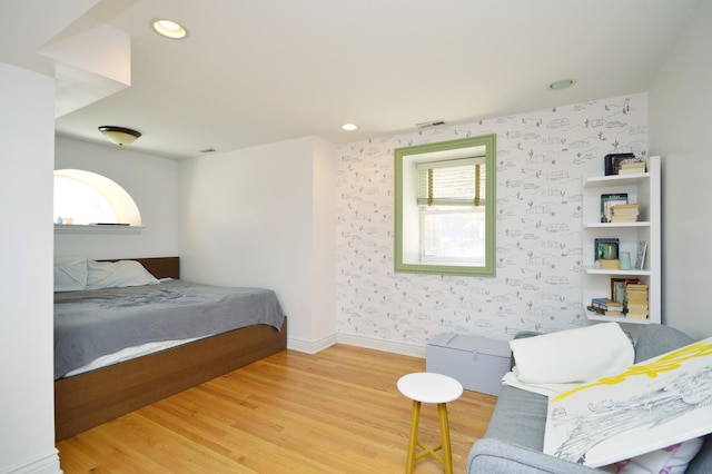 bedroom with multiple windows and wood-type flooring