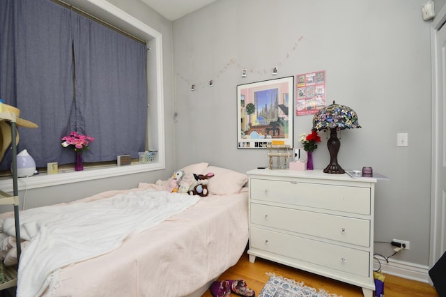 bedroom with hardwood / wood-style flooring