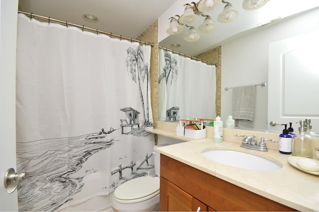 bathroom with a shower with curtain, vanity, and toilet