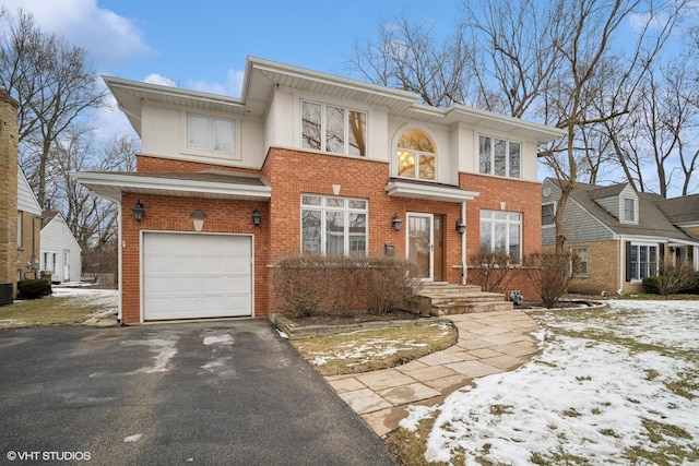 view of front of house featuring a garage and central AC