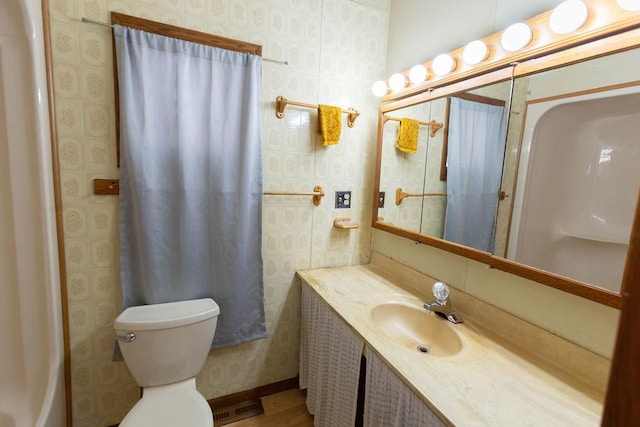 bathroom featuring vanity and toilet