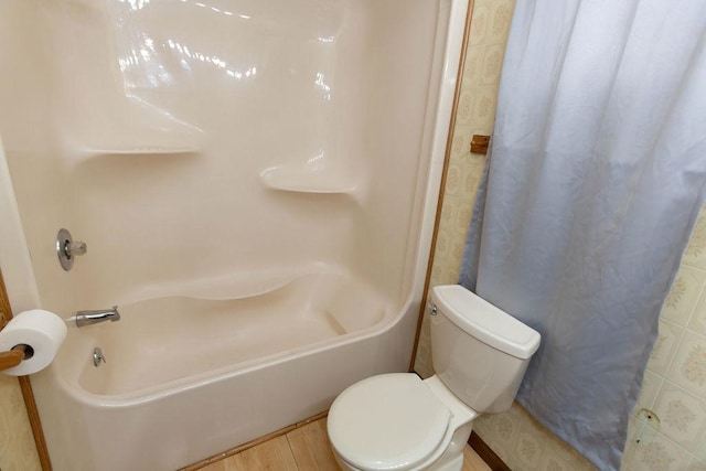 bathroom with hardwood / wood-style floors and toilet