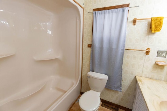 full bathroom with vanity, shower / bath combo with shower curtain, and toilet