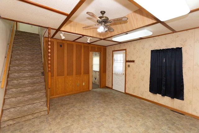 unfurnished living room featuring ceiling fan