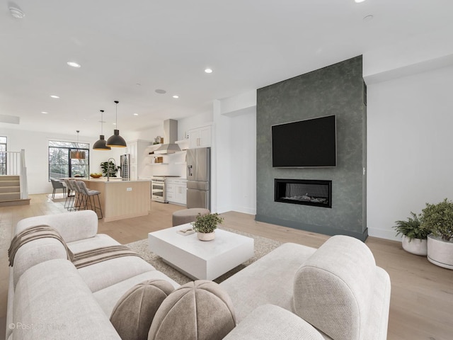 living room with a fireplace and light hardwood / wood-style floors