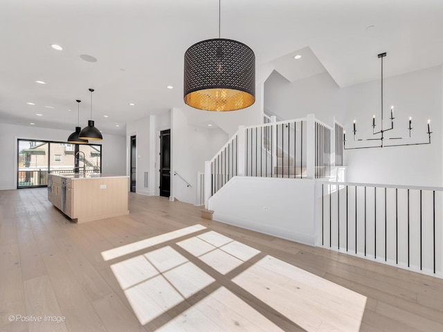 interior space featuring hardwood / wood-style flooring and an inviting chandelier