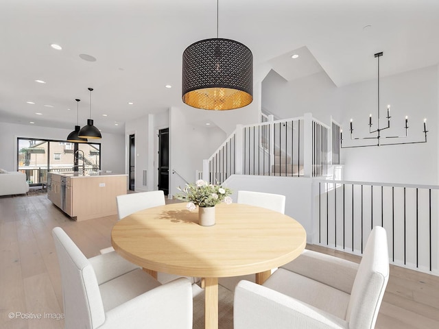 dining room featuring an inviting chandelier and light hardwood / wood-style floors