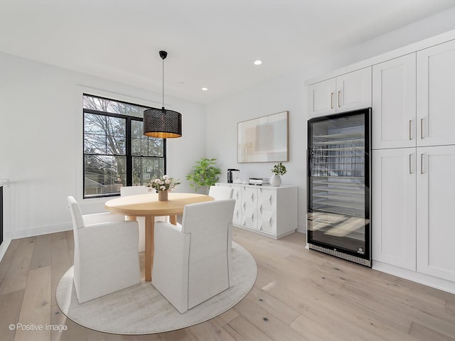 dining room with wine cooler and light wood-type flooring