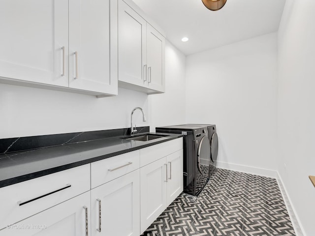 laundry area featuring cabinets, sink, and independent washer and dryer