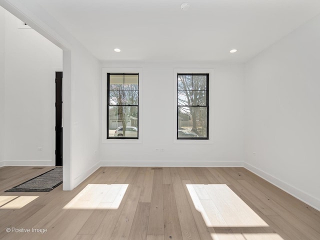 unfurnished room with light hardwood / wood-style floors