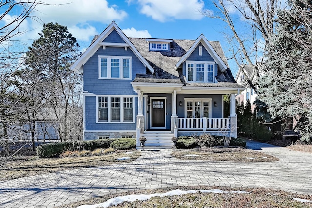 shingle-style home featuring covered porch