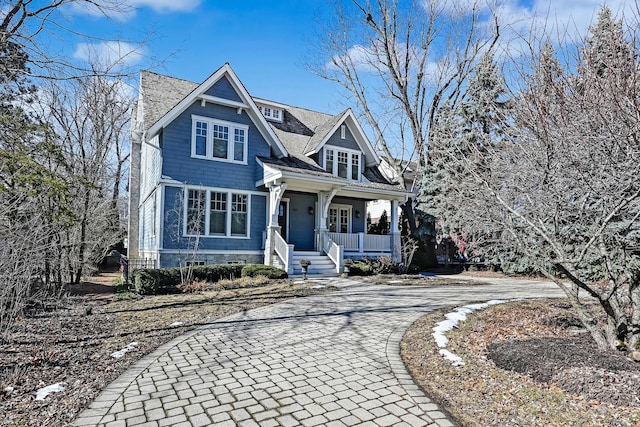 view of front facade with covered porch and decorative driveway