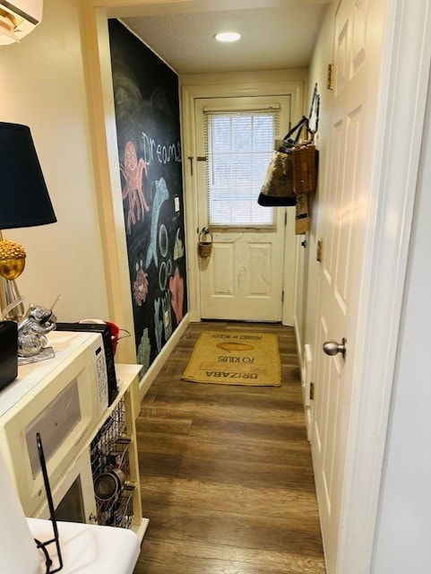 entryway featuring dark hardwood / wood-style floors and a wall unit AC