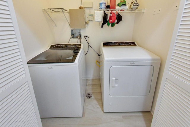 clothes washing area with washer and dryer