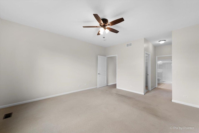 carpeted spare room with ceiling fan