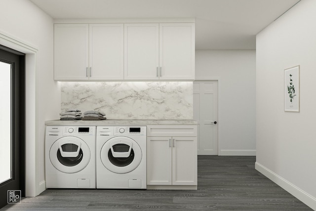 clothes washing area with dark hardwood / wood-style flooring, washer and clothes dryer, and cabinets