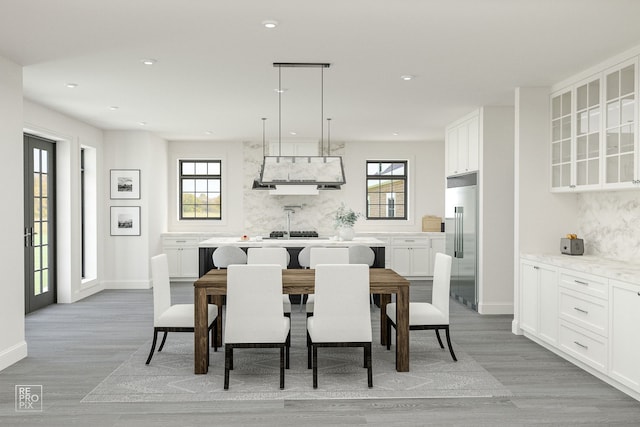 dining room featuring a healthy amount of sunlight and light wood-type flooring