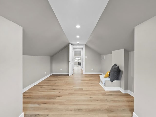 bonus room with light hardwood / wood-style flooring and vaulted ceiling