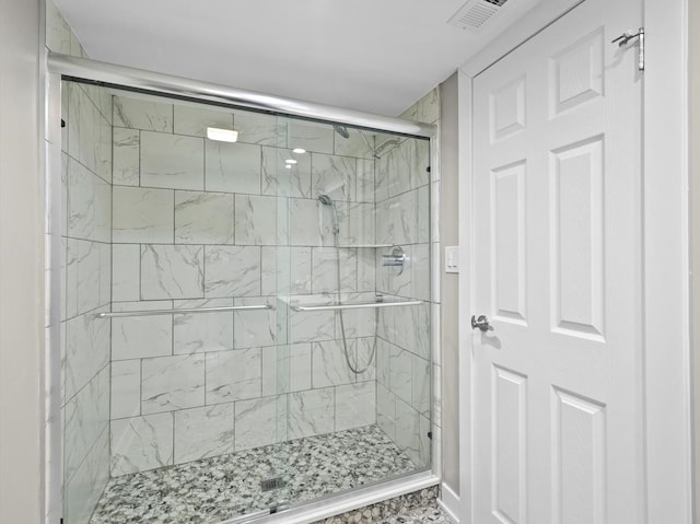 bathroom with a shower with shower door