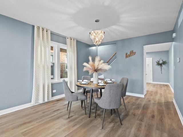 dining area featuring hardwood / wood-style flooring and a chandelier