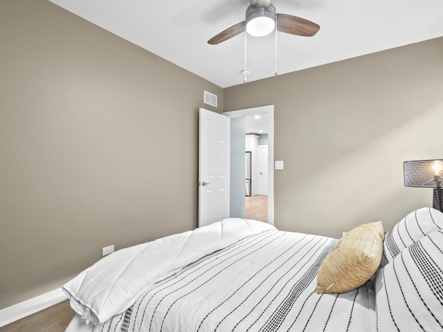 bedroom featuring wood-type flooring and ceiling fan