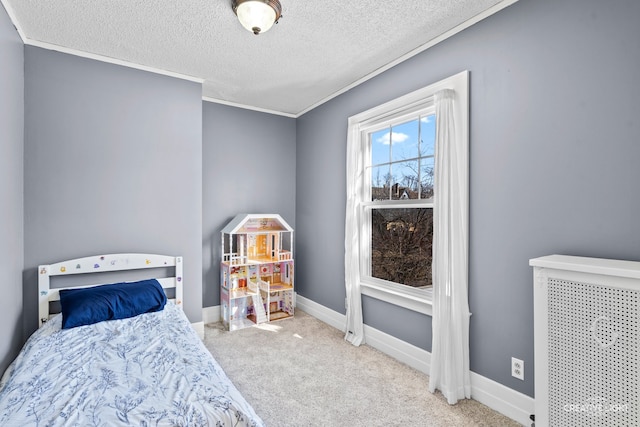 carpeted bedroom featuring ornamental molding and a textured ceiling