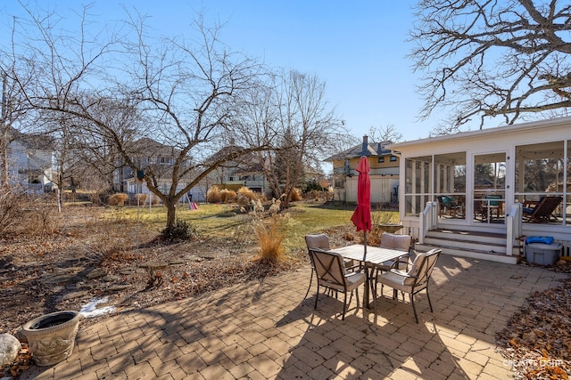 view of patio featuring a sunroom