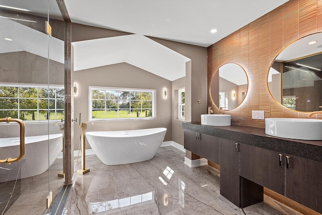 bathroom with lofted ceiling, vanity, and shower with separate bathtub