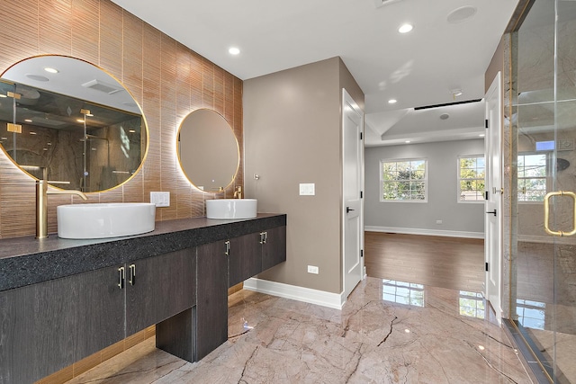 bathroom with vanity, tasteful backsplash, and walk in shower