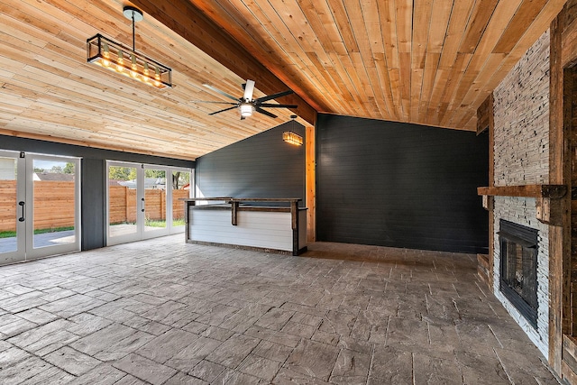 interior space with ceiling fan, a fireplace, and french doors