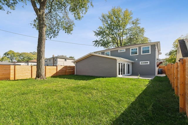 rear view of property with a yard and a patio