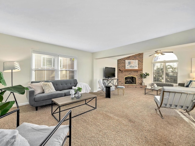 carpeted living room with a brick fireplace, baseboards, and a ceiling fan