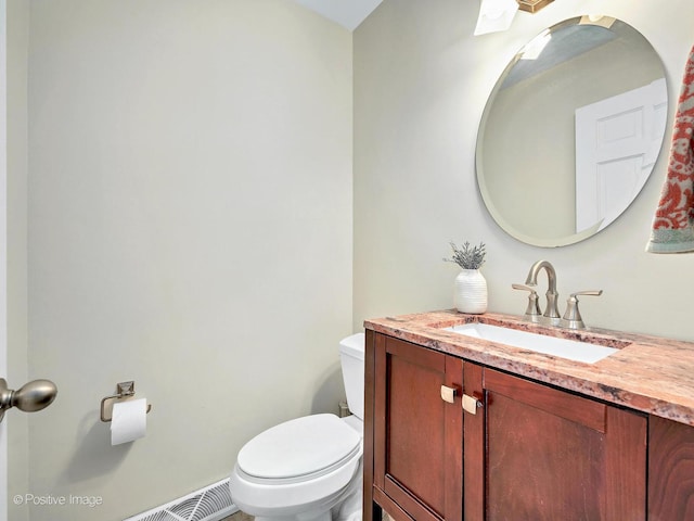 bathroom with toilet and vanity