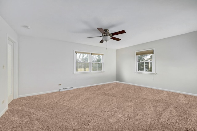 empty room featuring carpet floors, a baseboard heating unit, baseboards, and a ceiling fan