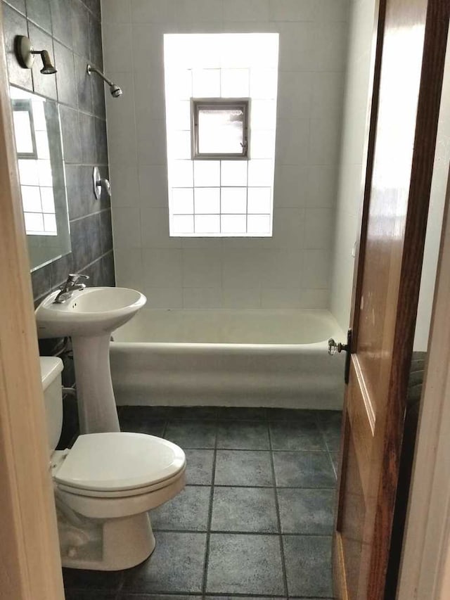 full bathroom with bathtub / shower combination, toilet, and tile patterned floors