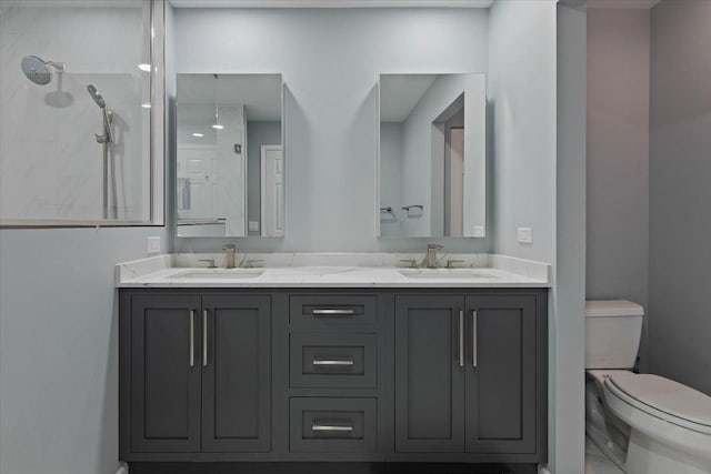 bathroom featuring vanity, toilet, and a shower