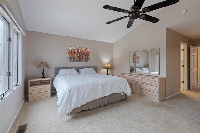 bedroom with ceiling fan, vaulted ceiling, and light carpet