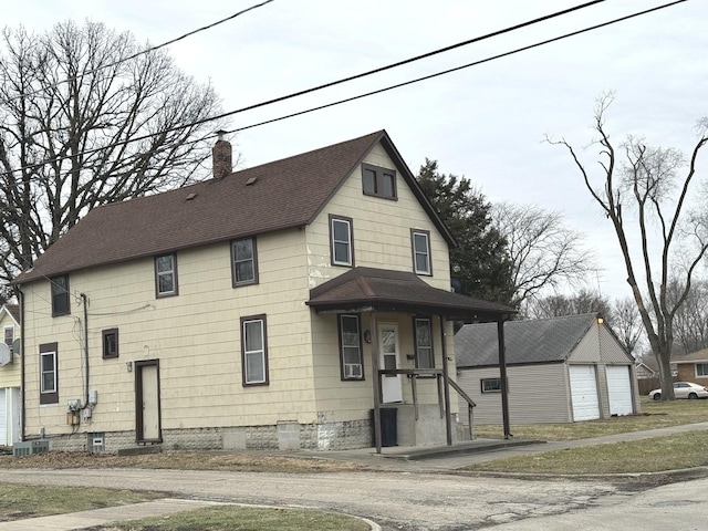 view of front of home with a garage, an outdoor structure, and central AC