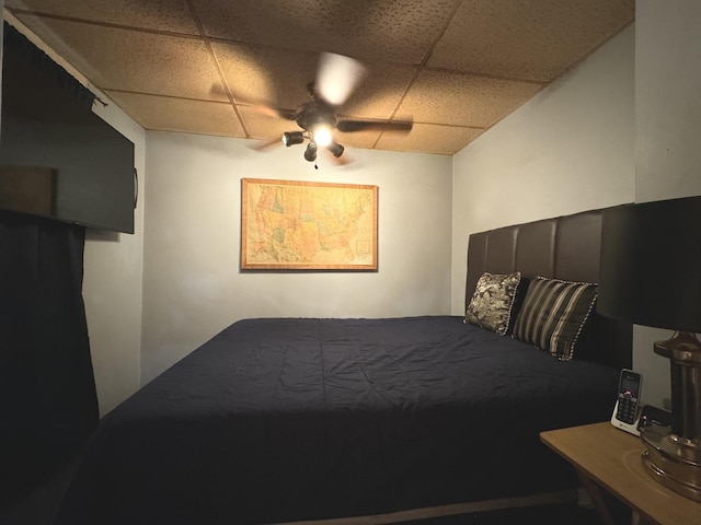 bedroom featuring ceiling fan and a paneled ceiling