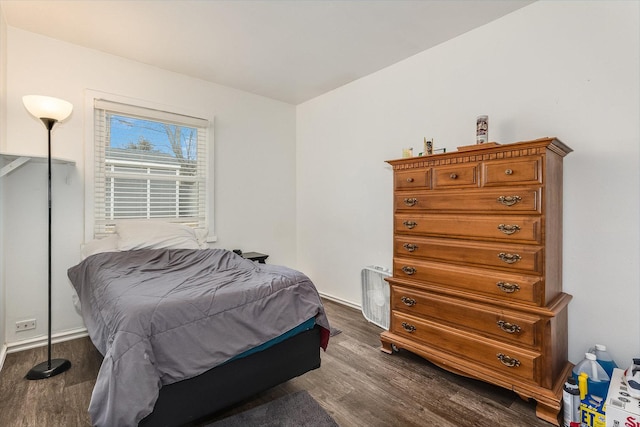 bedroom with dark wood-type flooring