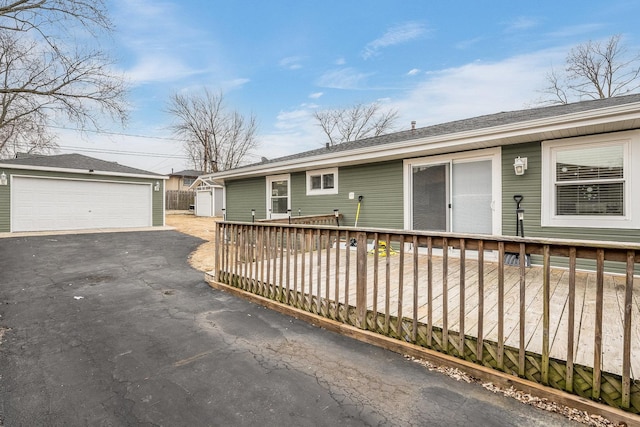 view of front of property with a garage and an outdoor structure